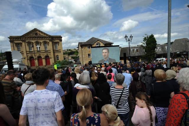 Onlookers listen to the speech by Brendan Cox, which was broadcast live from Trafalgar Square.