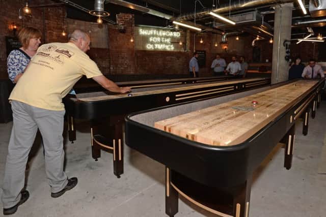 Customers play on the shuffleboards at the new BrewDog bar opened at Crispin Lofts, New York Road, Leeds. Picture: Anna Gowthorpe