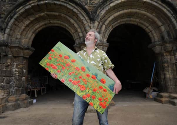 Artist David Starling pictured with one of his paintings at Kirkstall Abbey during the 2015 Kirkstall Art Trail