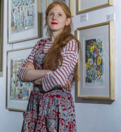 Artist Emily Sutton with her work.
Picture James Hardisty.