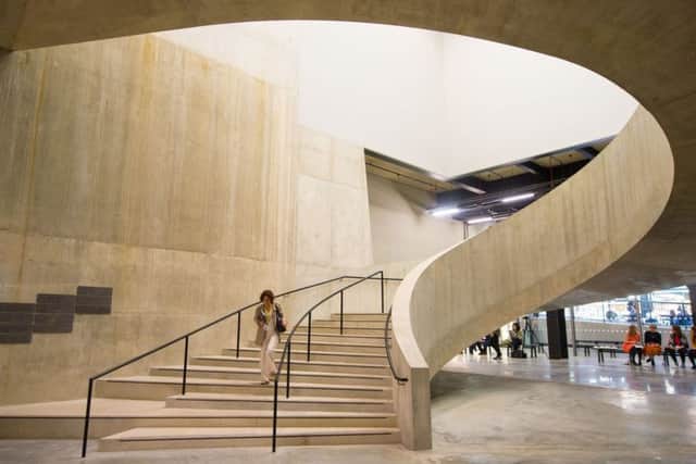 A visitor walking down a staircase in the new Switch House extension of the Tate Modern, in Southwark, London. PIC: PA