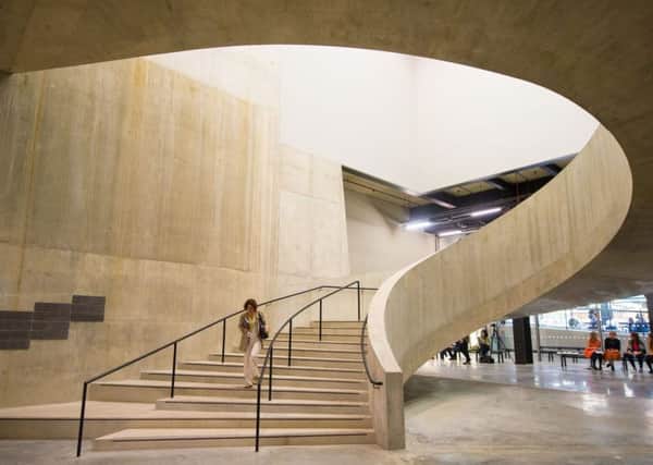 A visitor walking down a staircase in the new Switch House extension of the Tate Modern, in Southwark, London. PIC: PA