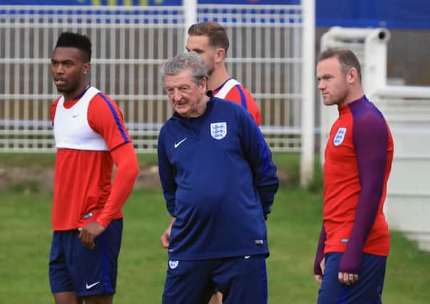 Daniel Sturridge, left, manager Roy Hodgson and Wayne Rooney during a training session at Chantilly. Picture: Mike Egerton/PA.