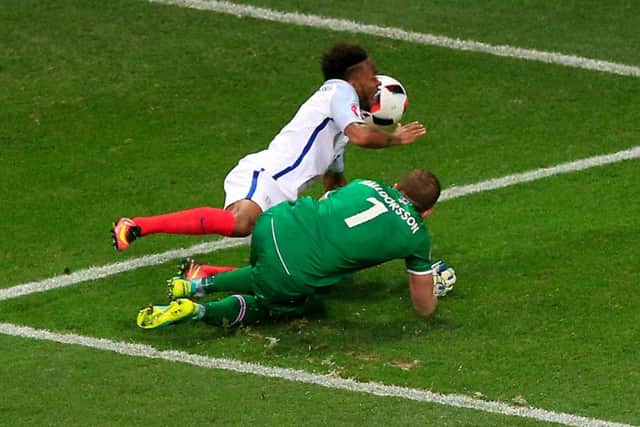 England's Raheem Sterling (left) is brought down by Iceland goalkeeper Hannes Thor Halldorsson to concede a penalty. Picture: Jonathan Brady/PA