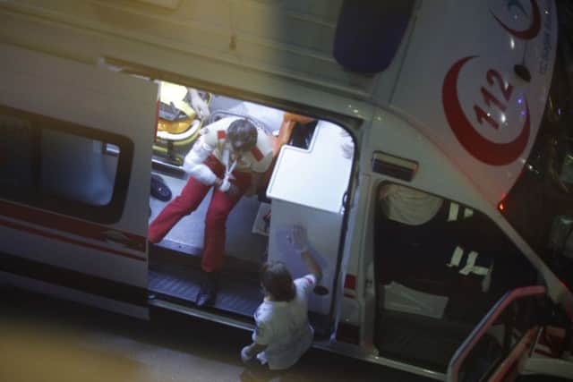 An injured person sits in an ambulance outside Istanbul's Ataturk airport.