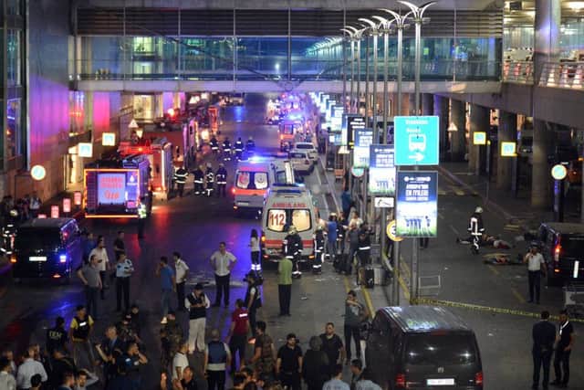 Medics and security members work at the entrance of the Ataturk Airport after explosions in Istanbul.
