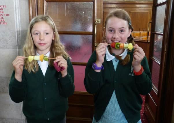 Pupils from Rawdon Littlemoor enjoying fruit kebabs at the healthy school awards.