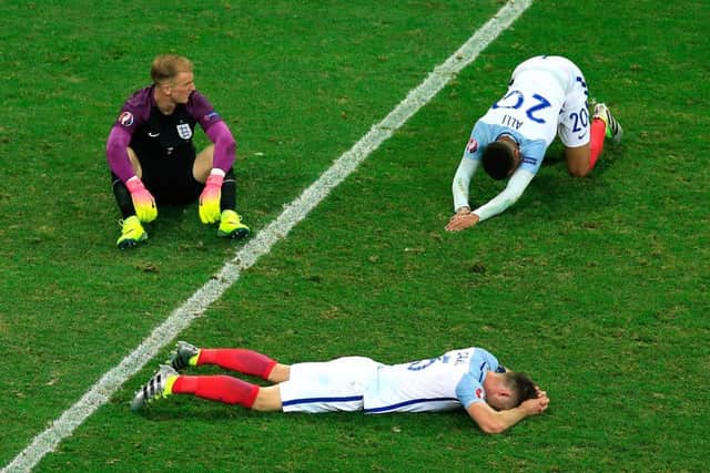 England goalkeeper Joe Hart (left) England's Gary Cahill (bottom) and England's Dele Alli show their dejection after the final whistle on Monday.