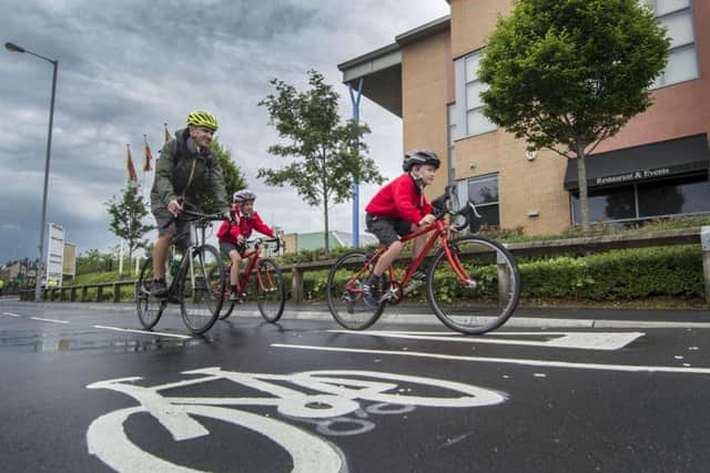 Dom Jacques, of Leeds, with his two children Frankie, 10, and Byron, seven, cycling on the newly opened City Connect route in Thornbury. Picture by James Hardisty.