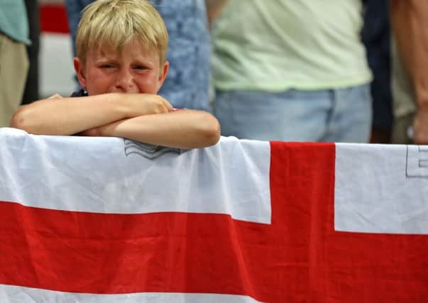 A young England fan sobs after seeing England beaten by Iceland at Euro 2016. Credit: Owen Humphreys/PA Wire.