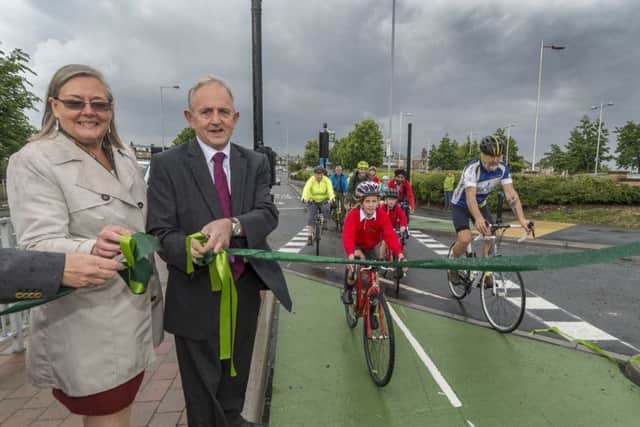 Coun Sarah Ferriby, of Bradford Council, and Coun Keith Wakefield, of Leeds City Council and West Yorkshire Combined Authority, unveil the first open section of City Connect at Thornbury Gyratory. Picture by James Hardisty.
