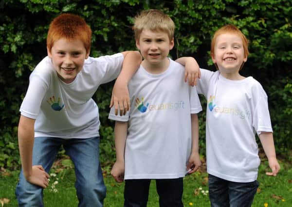 Euan Ashurst, seven, (centre) is to run a 1.5k run, ahead of the Leeds 10k. Euan is pictured with his  brothers Rory and Luke. PIC: Simon Hulme