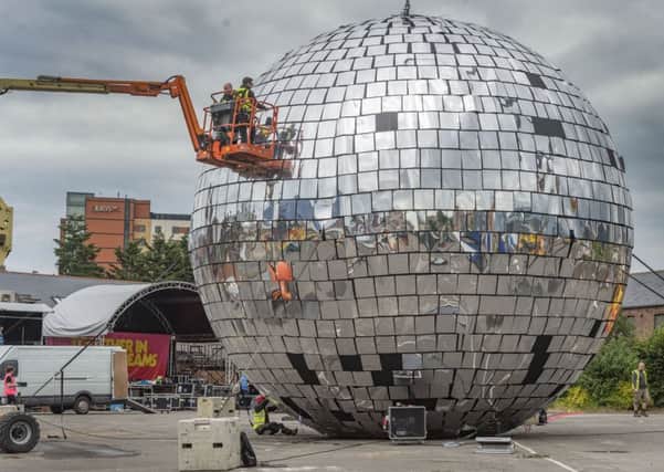 Putting the finishing touches to the World Largest Disco Ball that measures 10.33 metres in diameter, with 2500 mirrored titles, and over 11,000 zip ties, inreadiness for the Big Disco Event held in Leeds, near Duke Studios, Sheaf Street. Image: James Hardisty