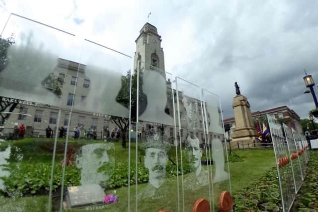 Barnsley Pals faces of Somme victims engraved on panels which will be lit at night outside the Town Hall.