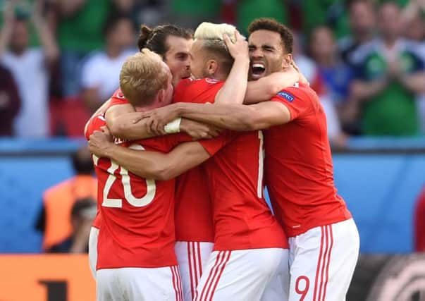Wales' Jonny Williams, Gareth Bale, Aaron Ramsey and Hal Robson-Kanu celebrate on the pitch after beating Northern Ireland in the last 16. Picture: Joe Giddens/PA.