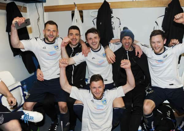 Guiseley's players celebrate in the dressing room after confirming their status in the National League for a second season. Picture: Steve Riding.