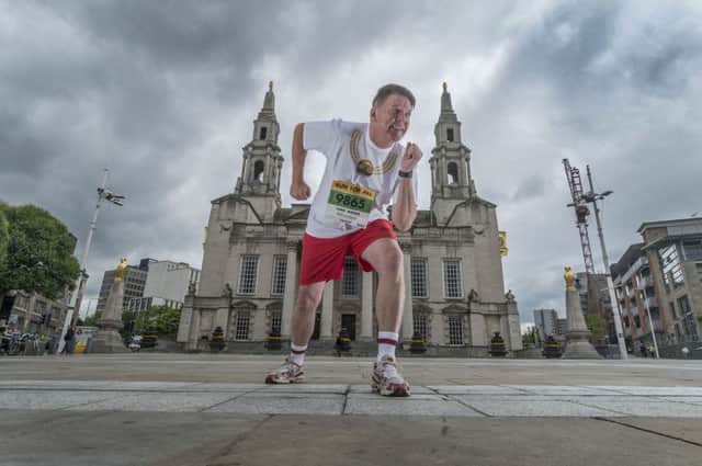 Lord Mayor of Leeds Coun Gerry Harper, warms up in preparation for the Leeds 10k wearing his special printed T-Shirt emblazoned with a picture of his chains of office.
