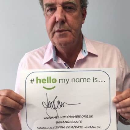 Jeremy Clarkson holding up his #hellomynameis sign.