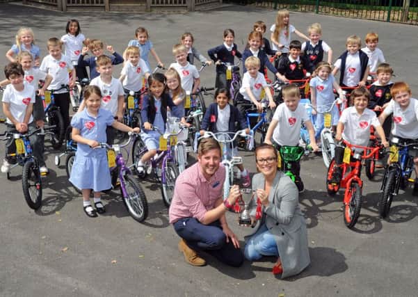 Teacher Dan Bogle and Heart Yorkshire's Emma Lenney pictured with pupils at Primrose Hill Primary School in Leeds.