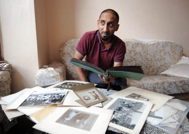 Mohammed Ilyas pictured with family photographs he found in the loft, at his home at Harehills Place, Leeds..SH10014216b..4th August 2015 Picture by Simon Hulme