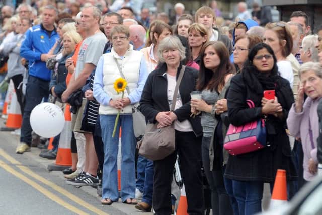Crowds line the streets in Heckmondwike as they wait for the cortege to travel through Heckmondwike. Picture Tony Johnson
