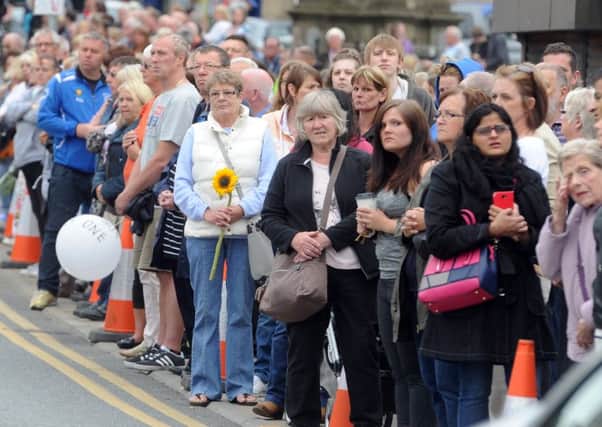 Crowds line the streets in Heckmondwike as they wait for the cortege to travel through the town. PIC: Tony Johnson