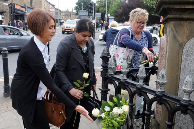 Constituents lay flowers at Heckmondwike's fountain clock. Picture Tony Johnson