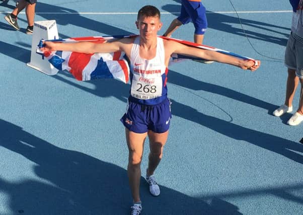 George Mills raises a British flag after winning in Georgia