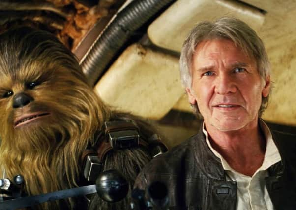 Chewbacca and Harrison Ford in a scene from "Star Wars: The Force Awakens