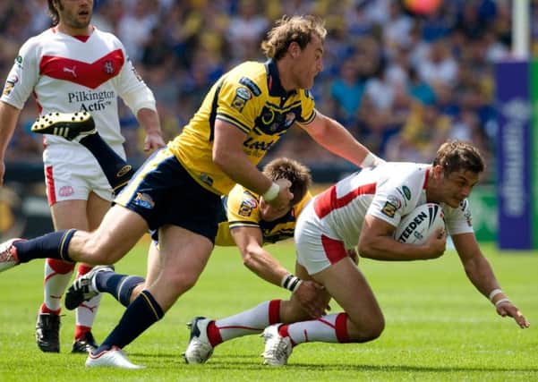 St Helens' Jon Wilkin is tackled by Leeds Rhinos' Gareth Ellis and Simon Worrall during the Carnegie Challenge Cup semi-final in 2008.