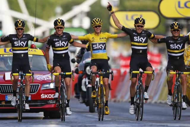 2016 Tour de France winner Chris Froome of Britain and his Sky teammates cross the finish line in Paris. Picture: AP/Peter Dejong.