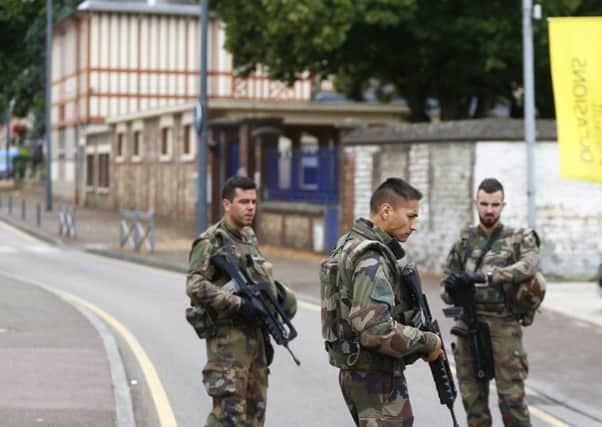 French soldiers stand guard near the scene of the attack in Saint-Etienne-du-Rouvray, Normandy