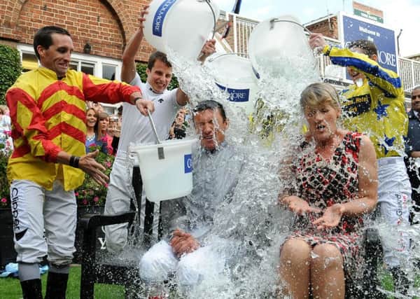 Jockey Frankie Dettori and presenter Clare Balding take part in the 'Ice Bucket Challenge' at York Racecourse, York. Celebrities who doused themselves with freezing cold water for charity have helped scientists make a discovery that could help sufferers of motor neurone disease.