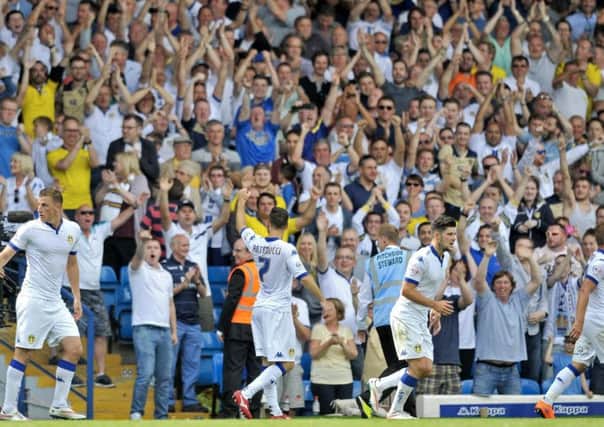 Fans cheer on Leeds United at Elland Road.