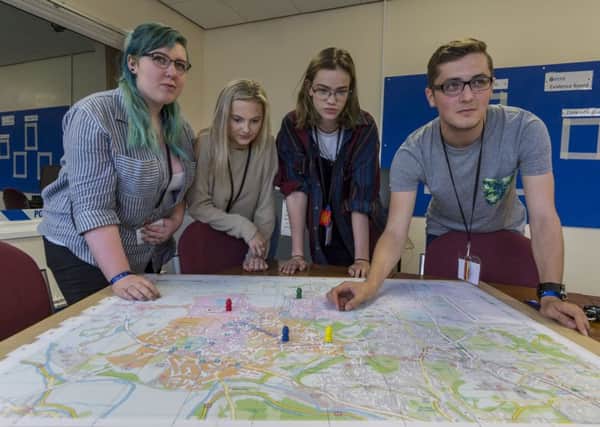 Bethany Sykes, Summer Greaves, Anna Aspinall, and Ryan Lane tackle the escape game set for them at Leeds Trinity University. Pictures: James Hardisty.