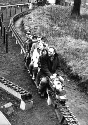 Leeds.  14th April 1963

Mr. Denis Thompson takes a party for a trip on the miniature railway at Temple Newsam, Leeds. (A Yorkshire Post picture.)

On the grounds of Temple Newsam House, Leeds, is a train service Dr. Beeching will never get his hands on.  Yesterday was the first open day of the year for this miniature railway completed in 1960 after six years' work by members of the City of Leeds Society of Model and Experimental Engineers.

The 1,000ft. circular trarck is mounted on concrete support about 2ft. from the ground.  The round trip is completed in about 80 seconds.

Mr. Ronald Jeffrey, secretary to the Society, showed me his own pride and joy, Kathleen, a 5in. gauge locomotive weight 1.25cwt. which can pull 30cwt. (10 to 13 people).  he built it himselft at a cost of Â£30.

The engines are very economical to run.  "I bought 1cwt. of coal about three years ago and I'm still using it," he said.

Mr. A. Bott, a Society member from Barton-on-Humber, Lincs., had brought his model, a 1500 class Great Wes