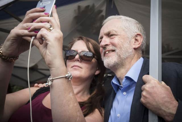 Jeremy Corbyn takes a selfie with a member of the public as he addresses a Labour leadership campaign rally at Queen's Gardens in Hull. PRESS ASSOCIATION Photo. Picture date: Saturday July 30, 2016. See PA story POLITICS  Labour. Photo credit should read: Danny Lawson/PA Wire