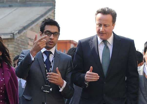 Then Prime Minister David Cameron meeting headteacher Sajid Hussain at Kings Science Academy, Bradford