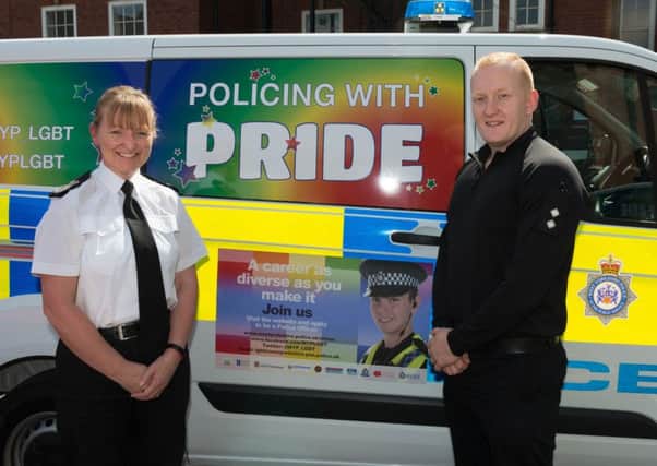 Temporary Chief Constable Dee Collins and Inspector Ben Ryder with one of the vans decked out ready for Leeds Pride.
