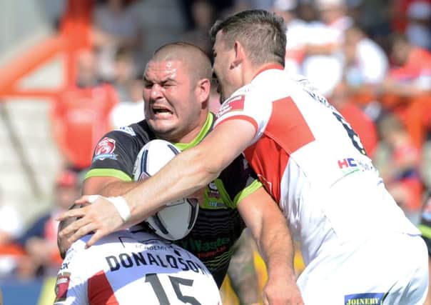 James Brown of Batley is tackled by James Donalson and Adam Walker of Hull KR.