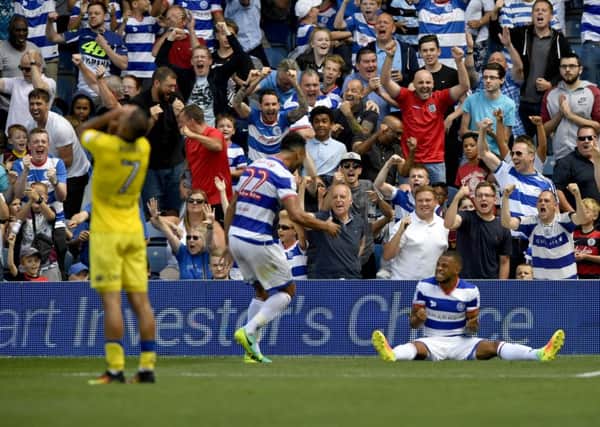 QPR players celebrate winning a penalty against Leeds United.