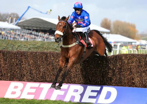 Cue Card ridden by jockey Paddy Brennan on the way to winning the Betfred Bowl Chase during the Grand Opening Day of the Crabbie's Grand National Festival at Aintree in April.