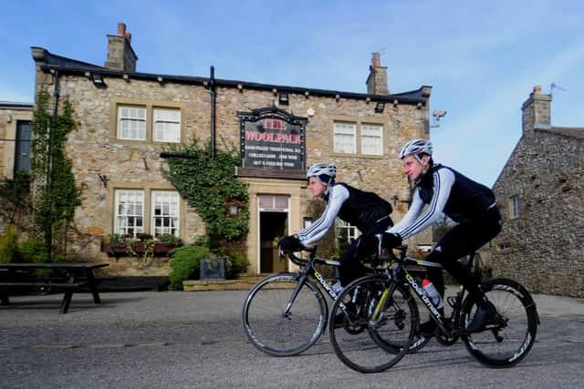 Jonathan and Alistair Brownlee cycle past The Woolpack during a training ride. Picture by Tony Johnson.