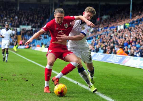 Leeds target, Bristol City defender Luke Ayling, tussles with want-away United defender Charlie Taylor.  PIC: Tony Johnson