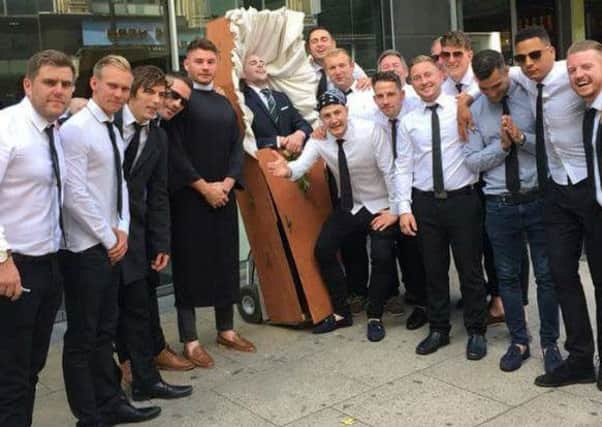 This is the hilarious moment a stag do dressed up the groom-to-be as a corpse and wheeled him around in a COFFIN - with his friends acting as mourners. See SWNS story SWSTAG. A group of Bristol lads on a stag do brought the centre of Manchester to a standstill at the weekend  because they put the groom in a coffin and wheeled him around as if he was dead. Chris White's mates took the old adage that getting married meant the end of one's bachelor life to its logical conclusion, with a stag-do joke that they were at his funeral, mourning the end of his freedom.