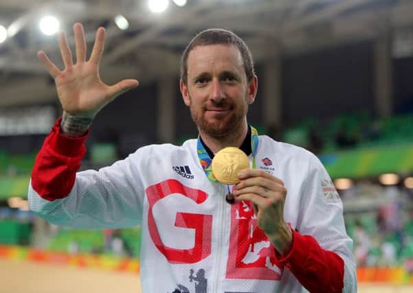 Great Britain's Sir Bradley Wiggins celebrates with his gold medal following victory in the men's team pursuit final.