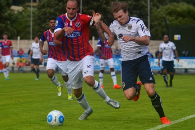 Guiseley's Jordan Preston, right, takes on Dagenham and Redbridge's Scott Doe. PIC: James Hedley.