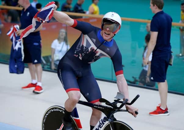 Ed Clancy celebrates crossing the line as the Great Britain team win gold in the Men's Team Pursuit First Final. Picture: Owen Humphreys/PA