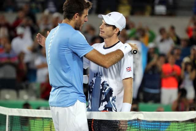 Great Britain's Andy Murray consoles Argentina's Juan MartÃn del Potro following victory in the men's singles final. Picture: Owen Humphreys/PA