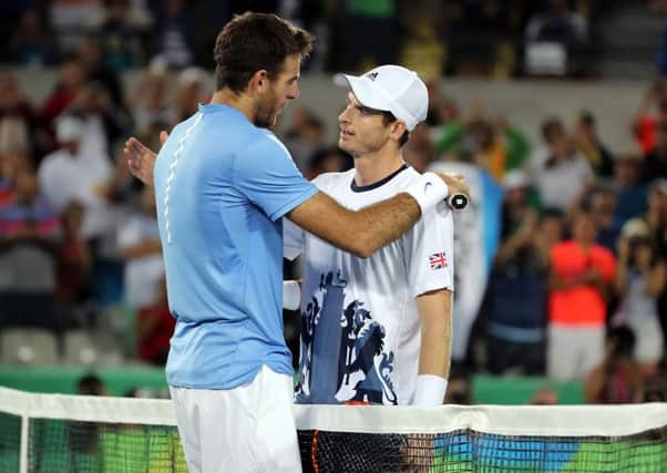 Great Britain's Andy Murray consoles Argentina's Juan MartÃ­n del Potro following victory in the men's singles final. Picture: Owen Humphreys/PA